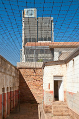 Number four prison building secured by barbed wire within the city of Johannesburg. South Africa.