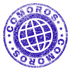 COMOROS stamp print with grunge texture. Blue vector rubber seal print of COMOROS text with unclean texture. Seal has words placed by circle and planet symbol.
