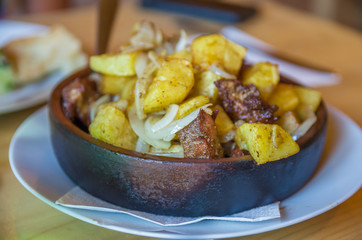 baked beef and potatoes in pan, cast-iron top view