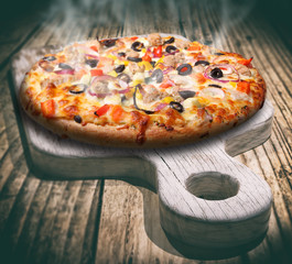 Pizza margherita and wooden old cutting board 