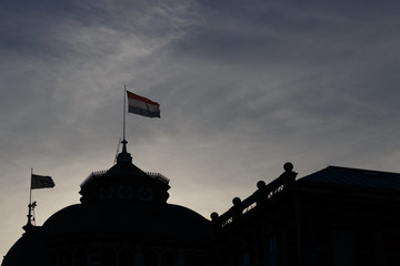 Dutch Flag on the building in Hague, high contrast against sky