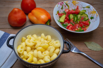 pasta and vegetable salad on a wooden table