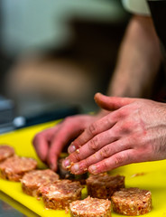 Male Chef Making Round Pork Cutlet for Some Burgers for  Wedding Meal