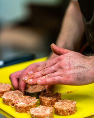Male Chef Making Round Pork Cutlet for Some Burgers for  Wedding Meal
