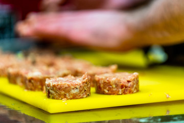 Male Chef Making Round Pork Cutlet for Some Burgers for  Wedding Meal