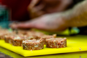 Male Chef Making Round Pork Cutlet for Some Burgers for  Wedding Meal