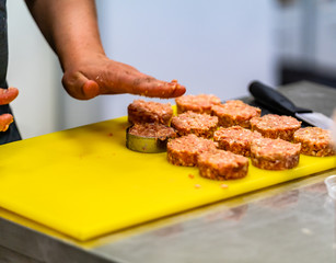 Female Chef Making Round Pork Cutlet for Some Burgers for  Wedding Meal