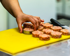 Female Chef Making Round Pork Cutlet for Some Burgers for  Wedding Meal