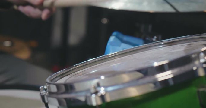 Close up of drum sticks hitting the drum