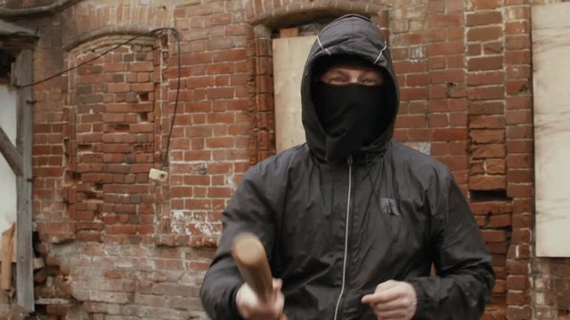 Aggressive hooligan with a baseball bat