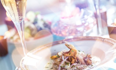 Close-up of Table with Food, Plates, Candles and Champagne