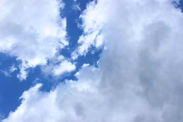 White and light gray cloud formations on deep blue sky river like