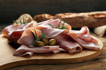 Sliced ham on wooden background. Fresh prosciutto. Pork ham sliced.