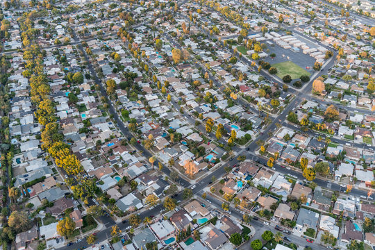 Late afternoon aerial view of houses and streets in the San Fernando Valley region of Los Angeles, California.