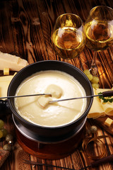 Gourmet Swiss fondue dinner on a winter evening with assorted cheese