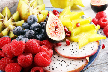 fruit bowl. Bowl of healthy fresh fruit salad on rustic background