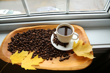 cup of coffee and beans on wooden table