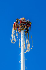 impressive image of the Papantla Flyers or flying pole before jumping with a wonderful blue sky an...