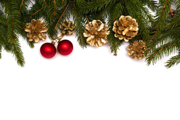 Christmas tree branches with red baubles and gold cones on white background.