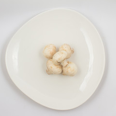 Fresh champignon mushroom on a plate