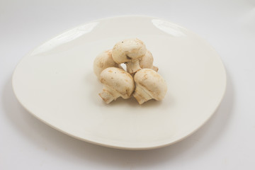 Fresh champignon mushroom on a plate