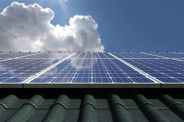 Solar panels modules on house roof with clear sky in background