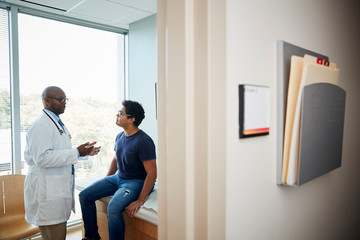 Doctor talking with male patient