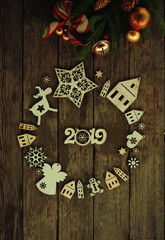 christmas and new year card with tree decorations/wooden figures of houses,snowflakes on the  rustic background