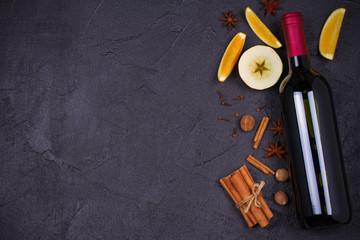 Bottle of red wine with spices, citrus fruits and apples for mulled wine hot drink. top view,...