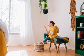 Girl sitting on a stool looking at a golden voucher
