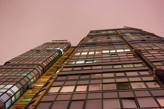 Modern office or residential building in the evening. Viewe from grownd to sky