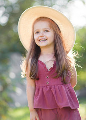 portrait of little girl outdoors in summer