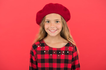 Kid little cute girl smiling face posing in hat red background. Fashionable beret accessory for female. How to wear french beret. Beret style inspiration. How to wear beret like fashion girl