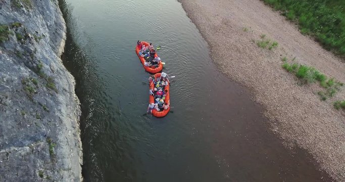 Epic Rafting Two Orange Boat on Shallow Mountain Forest Zilim River in Ural Mountains, Russia at summer sunny day - Aerial view