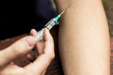 Man addicted with syringe injecting 