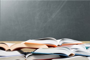 Books are opened and piled together on