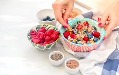High protein healthy breakfast, buckwheat porridge with blueberries, raspberries, flax seeds and honey Closeup view, selective focus