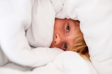 Portrait of a boy wrapped in a duvet