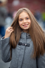 Photo of smiling girl in gray coat