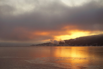 Sunrise and smoke from factory over Drammens fjord.