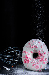 Delicious and flavorful donut with white icing. Donut with icing and dressing. Delicious donut on a...
