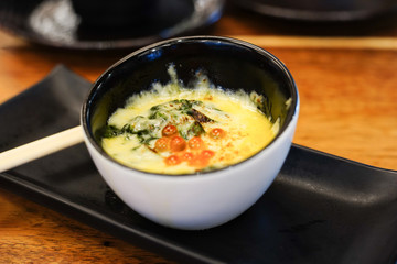 Baked spinach with cheese in japanese restaurant.