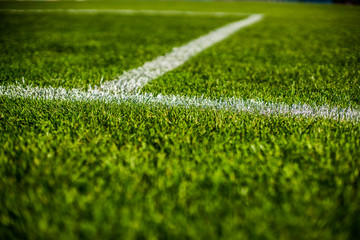 Fototapeta Green bright colorful grass pitch of football stafium, close up with beautiful bokeh and stripes obraz