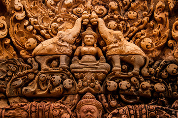 buddha with elephants carved into wall in Cambodia