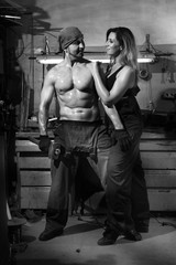 Man and a beautiful woman in a metalwork shop.