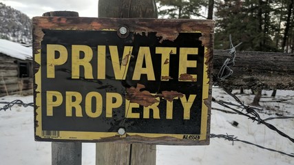 Old private property sign in the snow