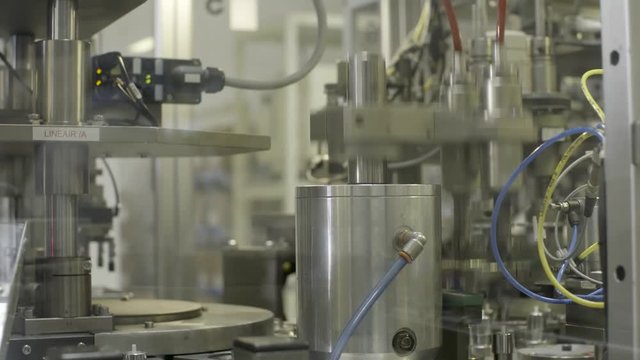 Robotic arm moving pices of metal from left to right