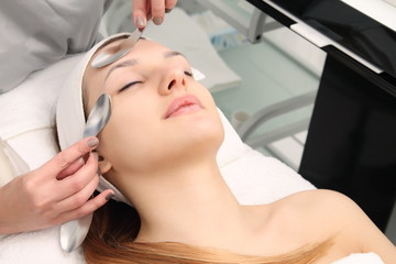 Beautiful woman at facial massage at a spa salon.