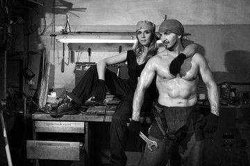 Man and a beautiful woman in a metalwork shop.