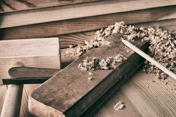Shaving plane wooden shavings hammer flat chisels construction concept.
